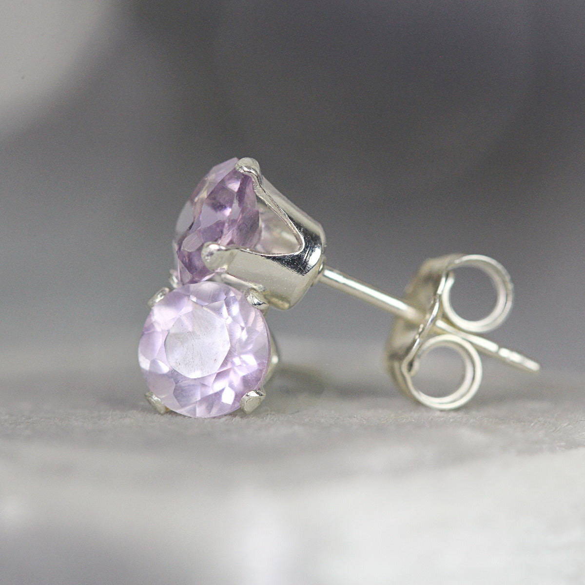 Simple, minimal round stud earrings made with amethyst gemstones set into sterling silver ear posts. Available in various sizes including 3 milimetres diameter, 4 milimetres diameter, 5 milimetres diameter and 6 milimetres diameter.
