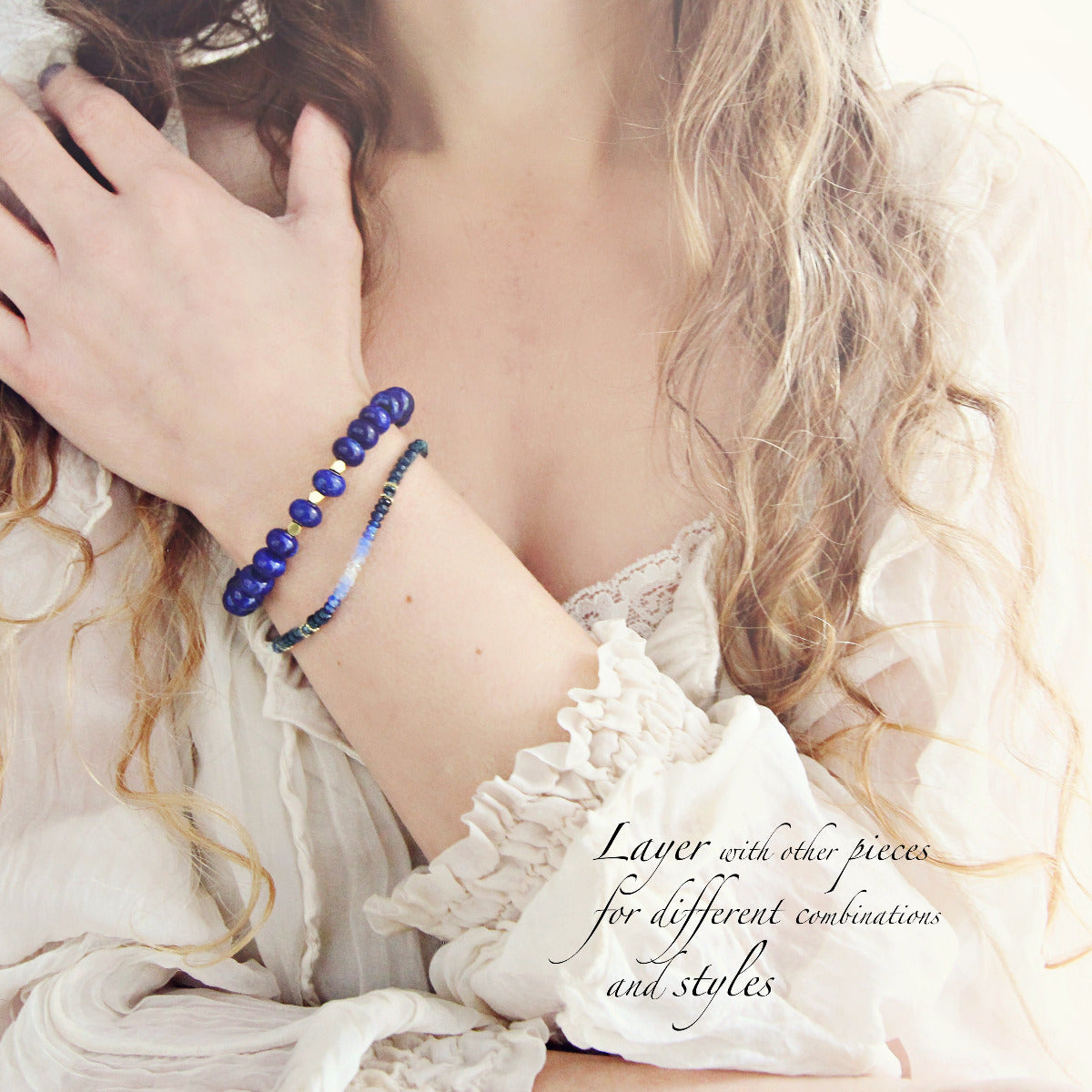 Person wearing a dainty blue beaded sapphire bracelet and a chunky blue lapis lazuli bracelet