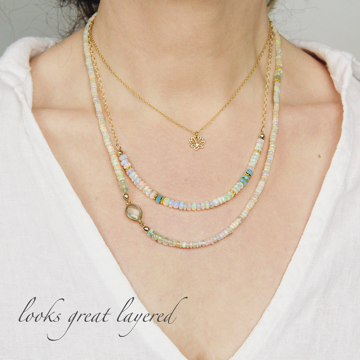 Opal beaded necklace with beaded chain and gold accents on a white background