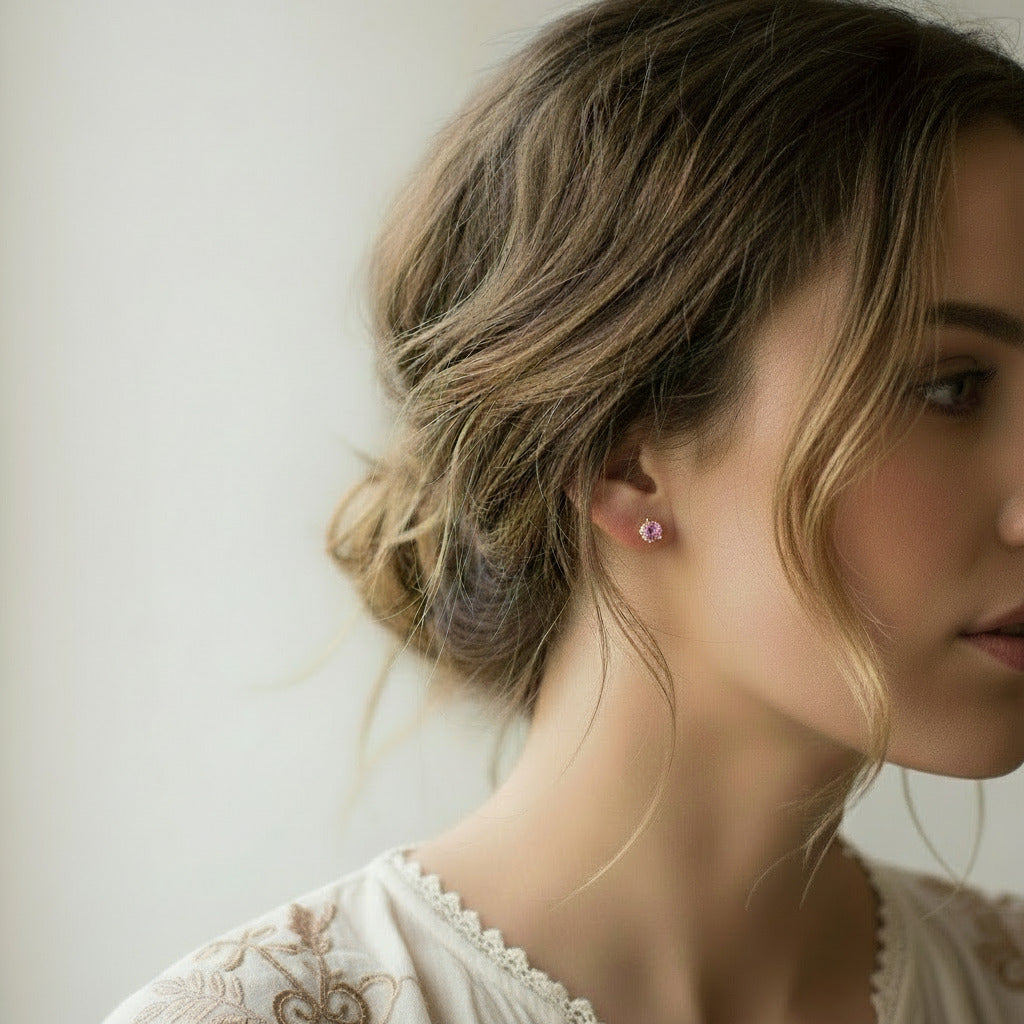 Pink crystal stud earrings featuring a faceted round cubic zirconia gemstones. The sparkling cz stones are set into a 4 prong gold setting. The studs are round in shape with ear post fitting matching butterfly backs. The earrings are simple and minimal in style. Various sizes available.