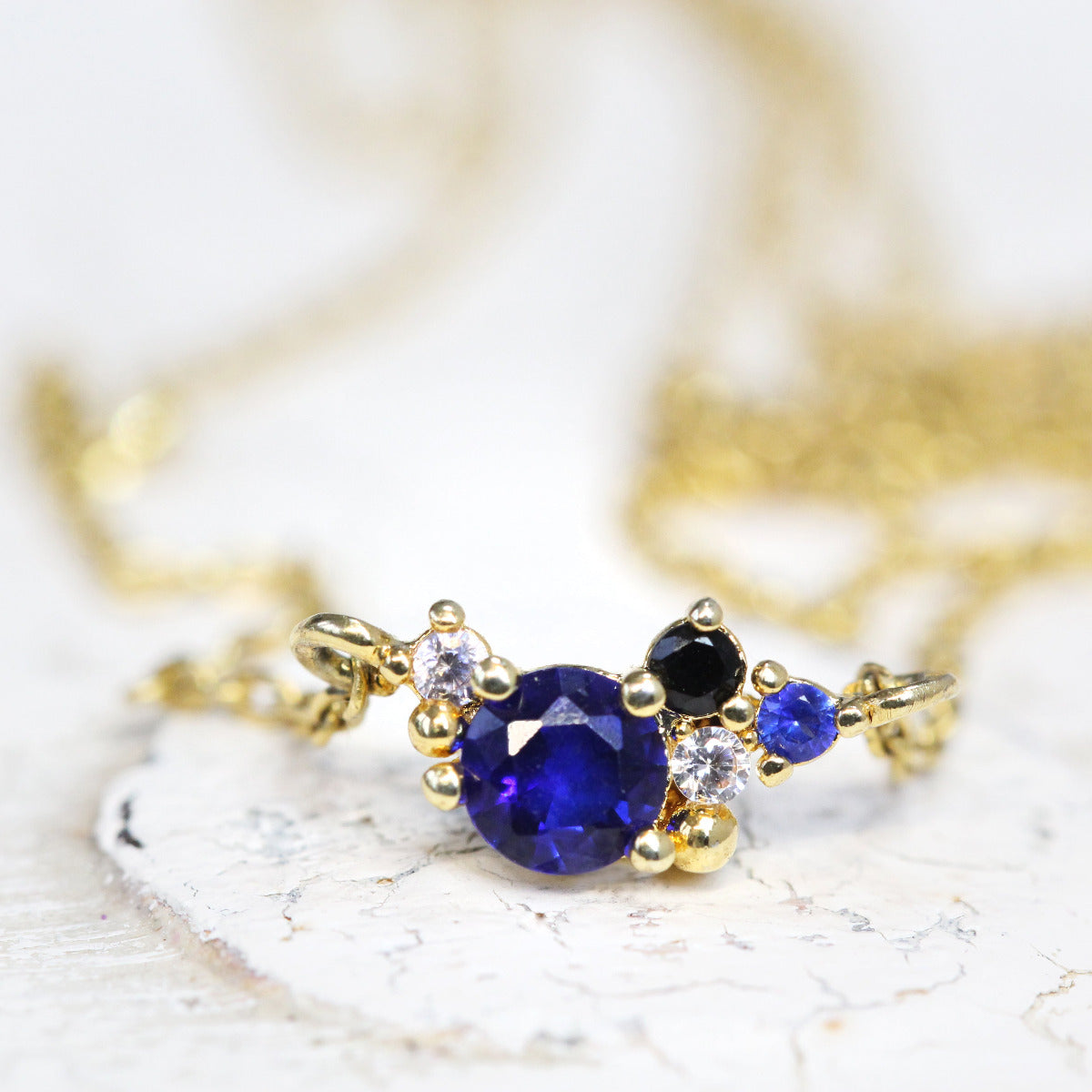 A cubic zirconia September Birthstone Cluster Necklace in Gold