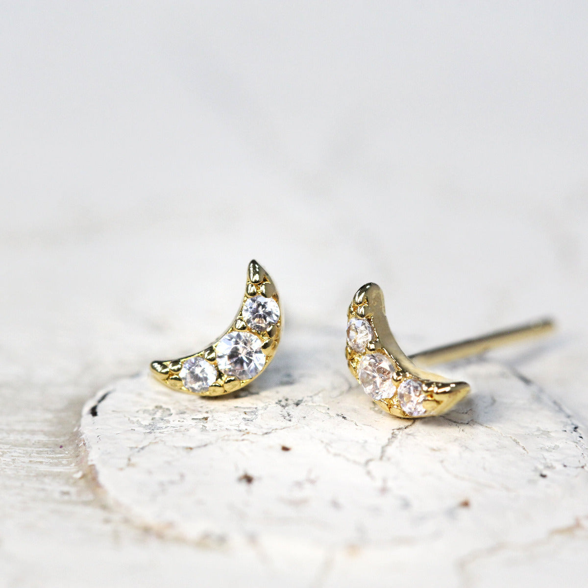 Tiny Crystal Moon Stud Earrings in Gold on a white background