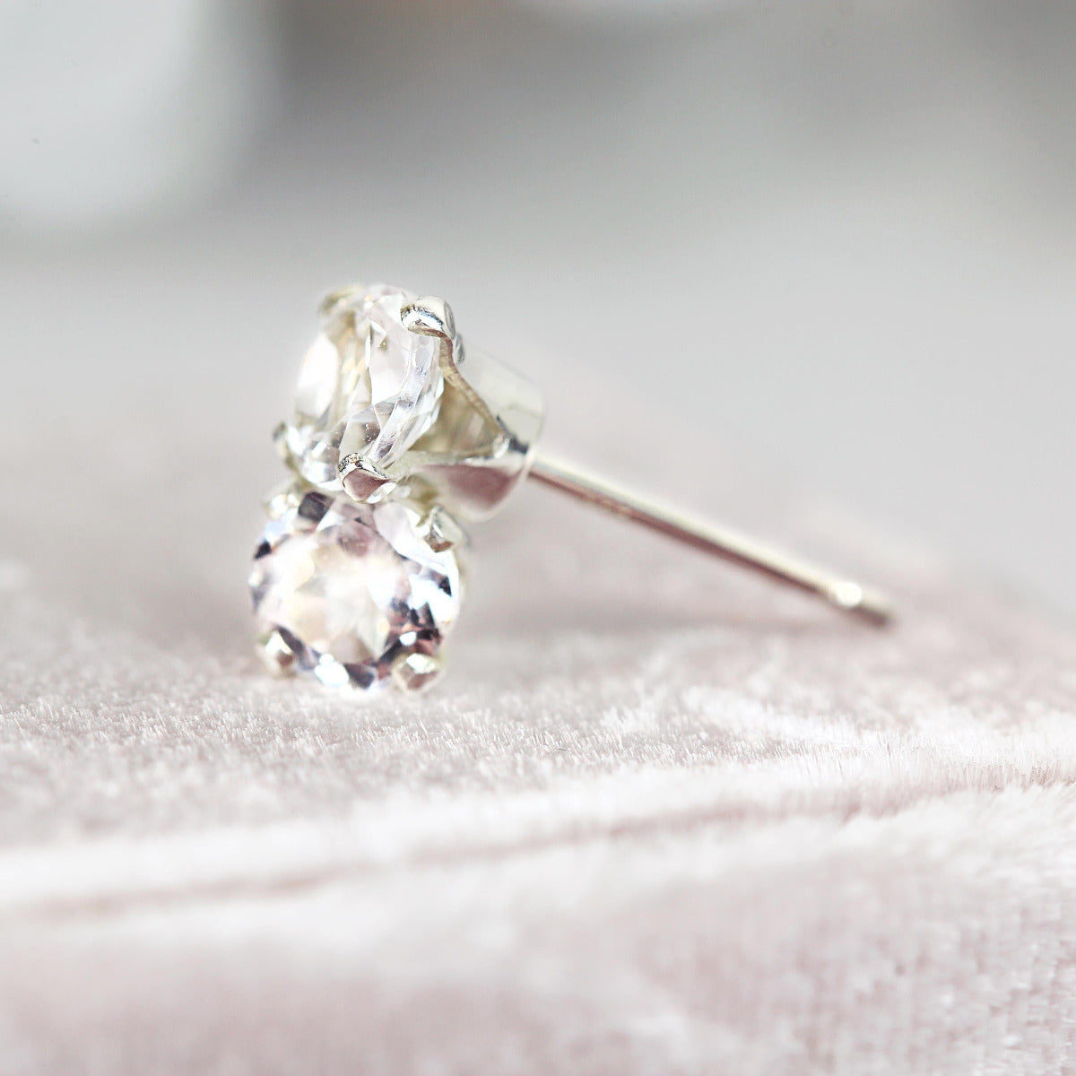 Simple, minimal round stud earrings made with white topaz gemstones set into sterling silver or gold fill ear posts. Available in various sizes including 3 milimetres diameter, 4 milimetres diameter, 5 milimetres diameter and 6 milimetres diameter.