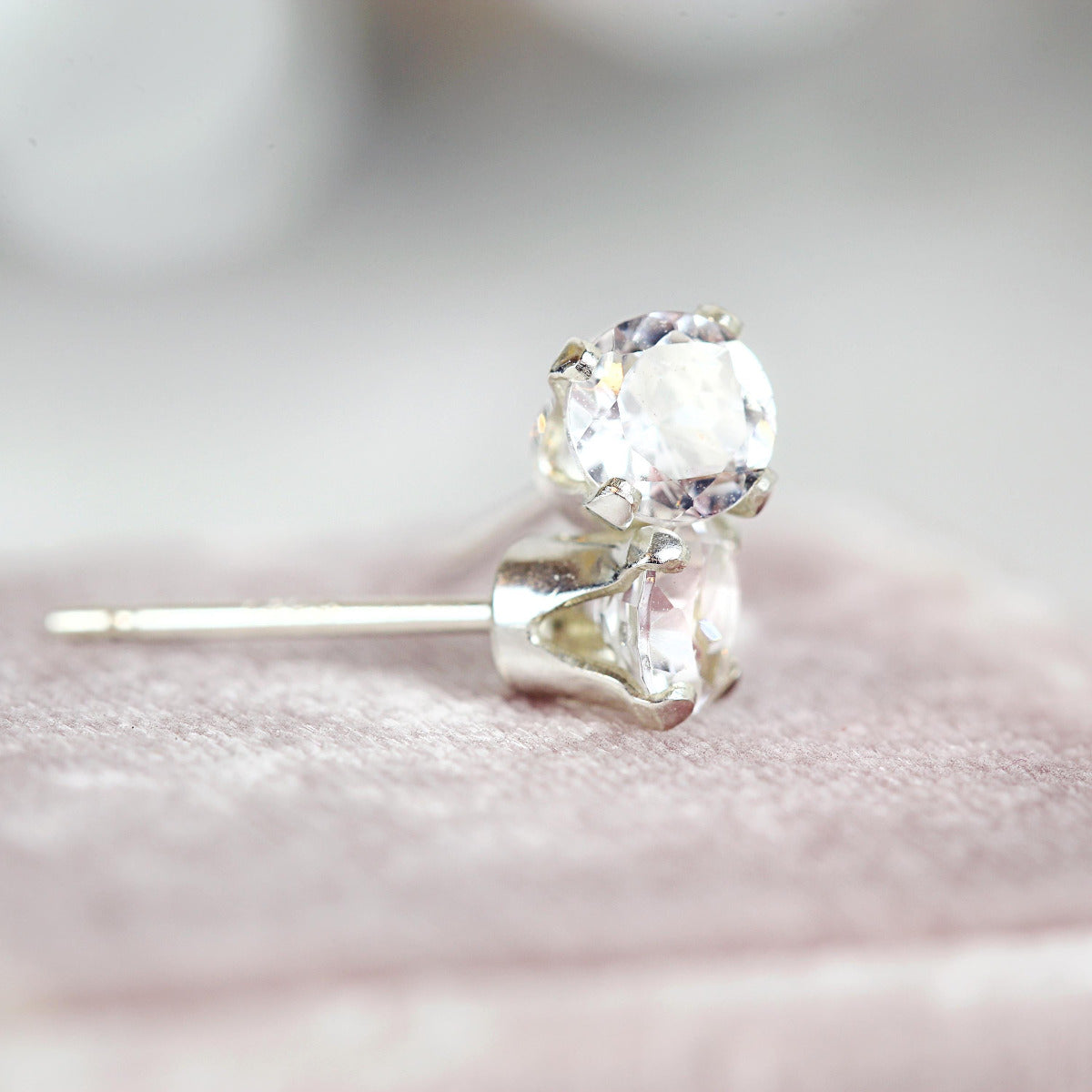 Simple, minimal round stud earrings made with white topaz gemstones set into sterling silver or gold fill ear posts. Available in various sizes including 3 milimetres diameter, 4 milimetres diameter, 5 milimetres diameter and 6 milimetres diameter.