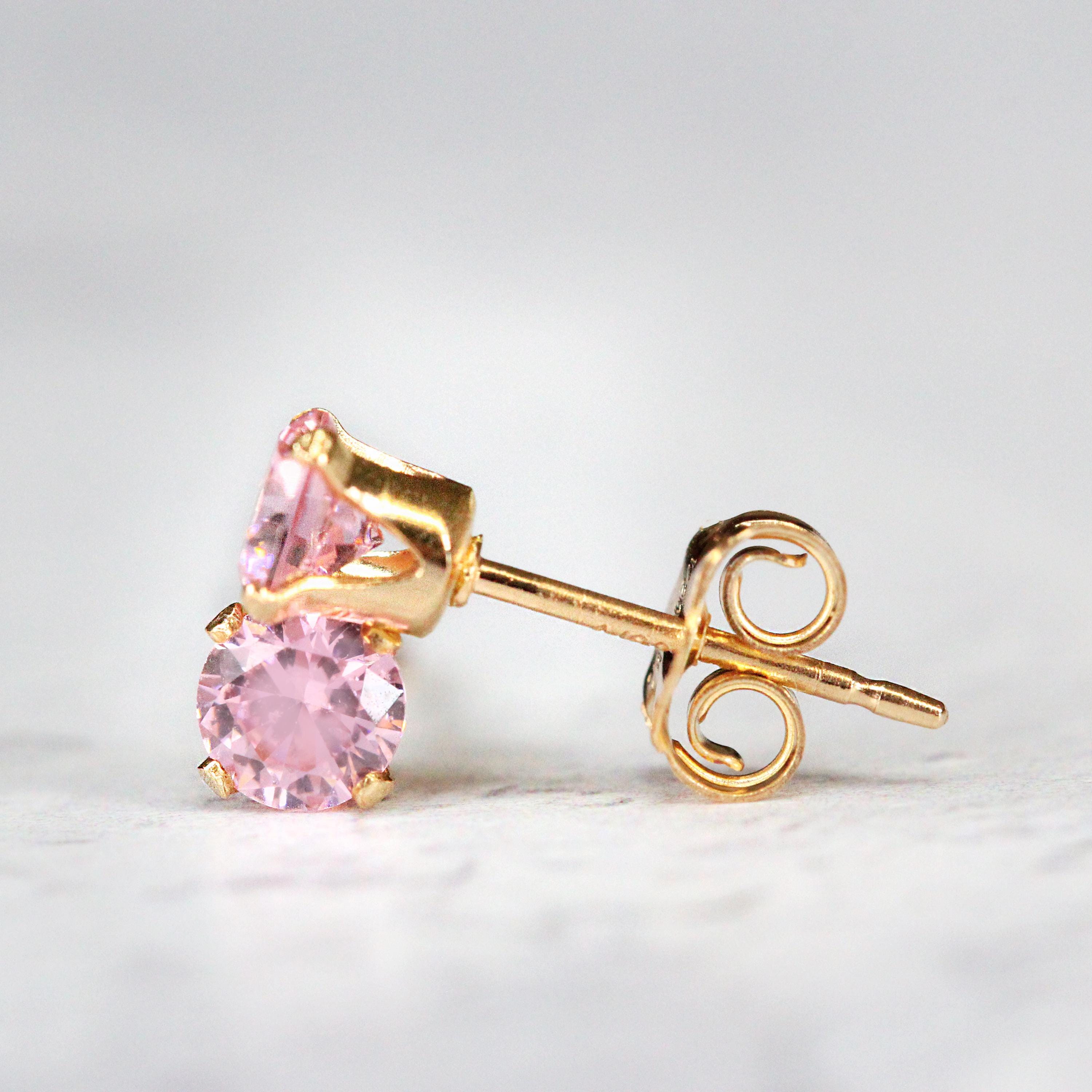 Handmade gold fill stud earrings featuring faceted rose pink cubic zirconia gemstones in a prong setting. Round in shape, with ear post fitting and matching butterfly backs. The earrings are simple minimal and elegant in style, and come in various sizes.