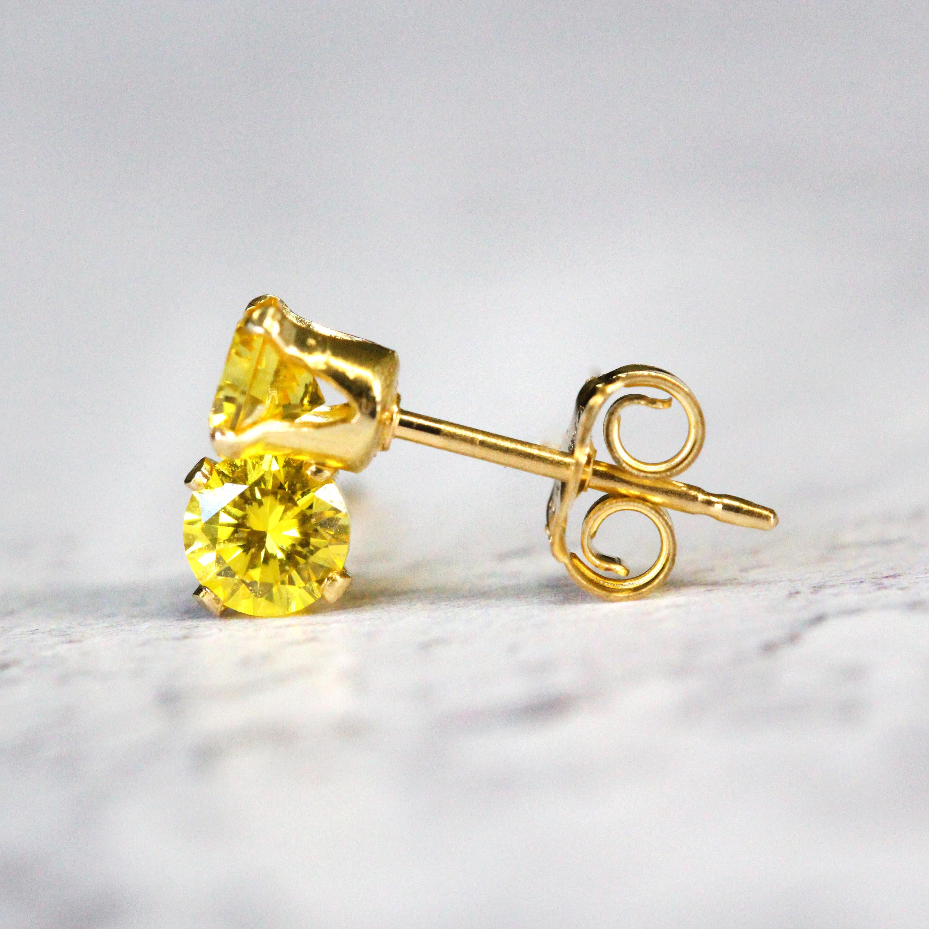 Handmade gold fill stud earrings featuring faceted bright yellow cubic zirconia gemstones in a prong setting. Round in shape, with ear post fitting and matching butterfly backs. The earrings are simple minimal and elegant in style, and come in various sizes.