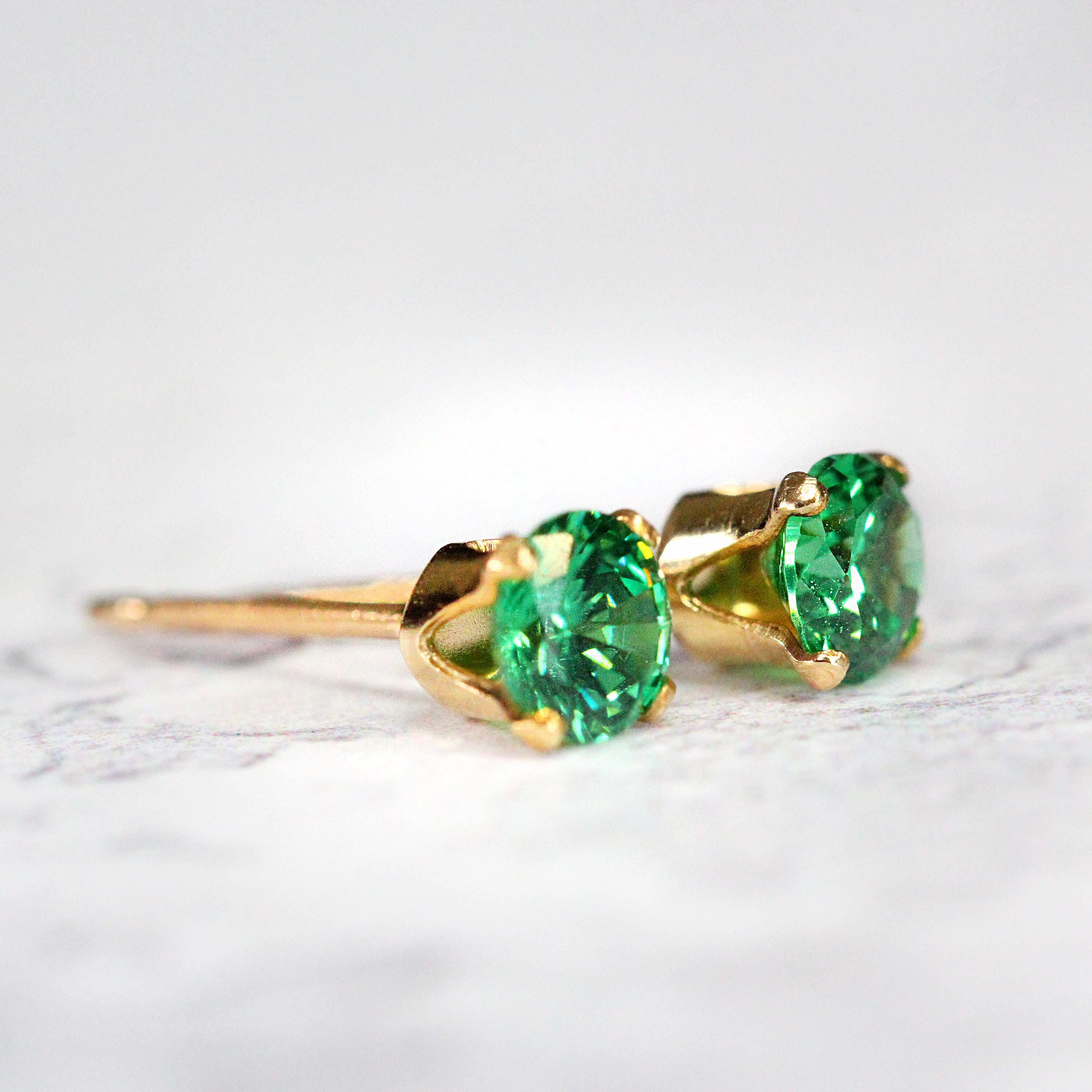 Simple, minimal round stud earrings made with rich teal green cubic zirconia gemstones set into sterling gold fill ear posts. Available in various sizes including 3 milimetres diameter, 4 milimetres diameter, 5 milimetres diameter and 6 milimetres diameter.